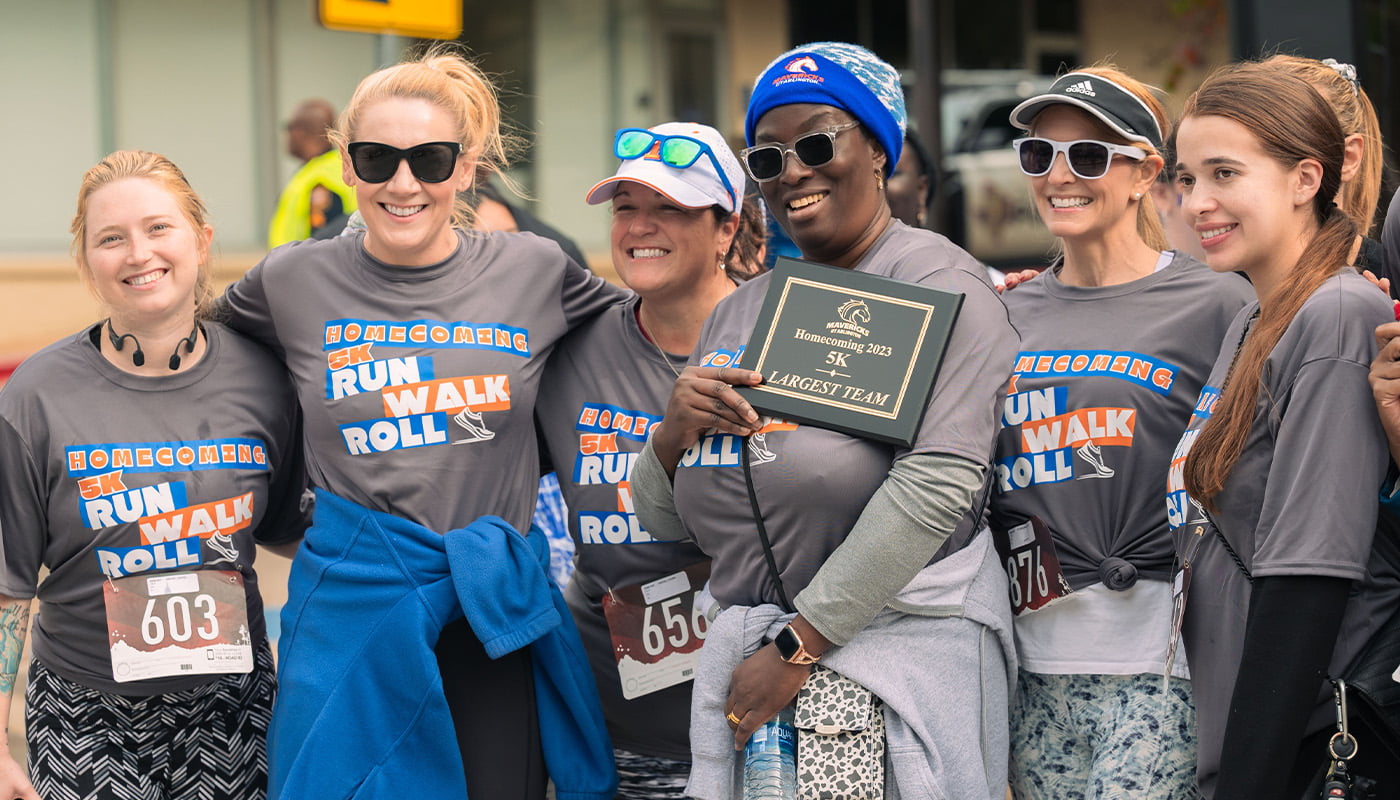 participants in the homecoming 5k pose for a photo