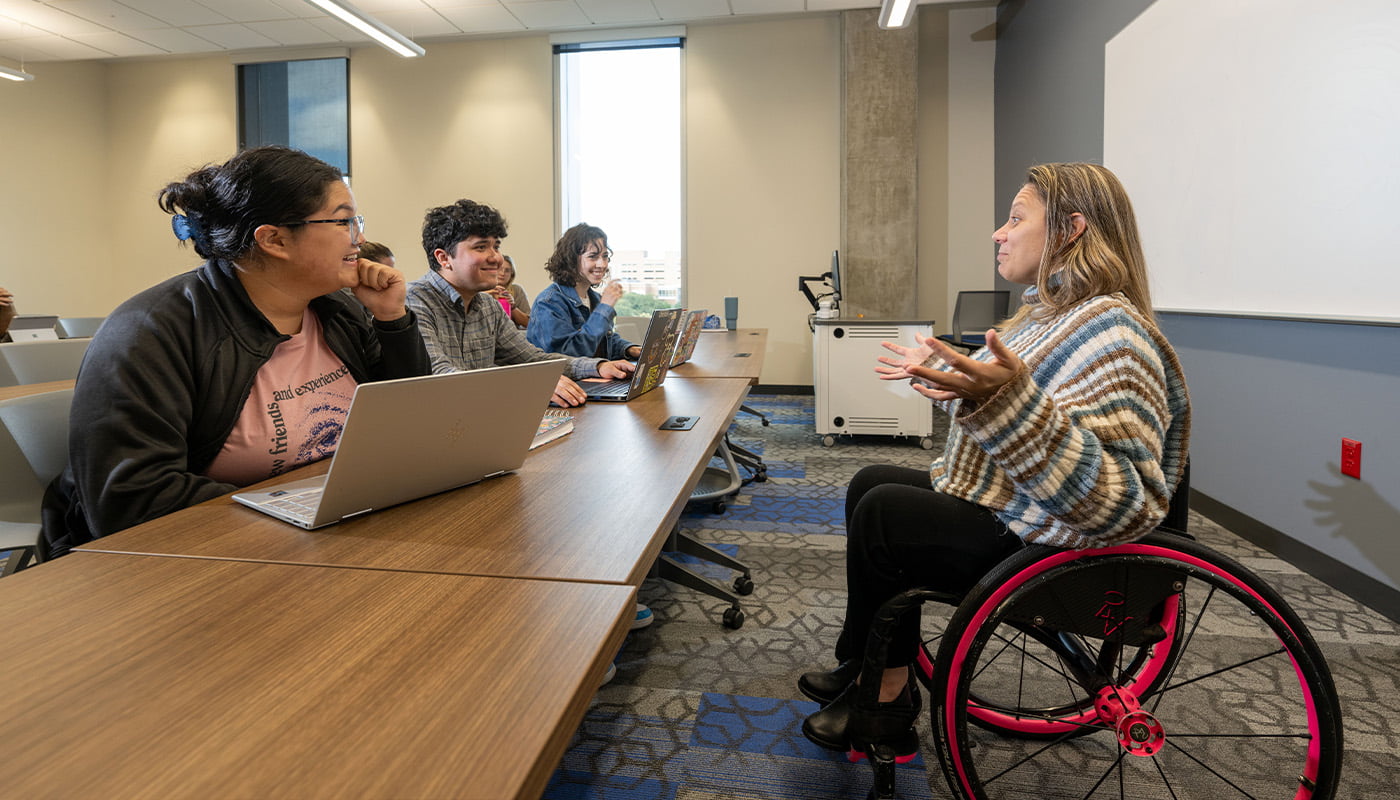 a professor in a wheelchair leading a class