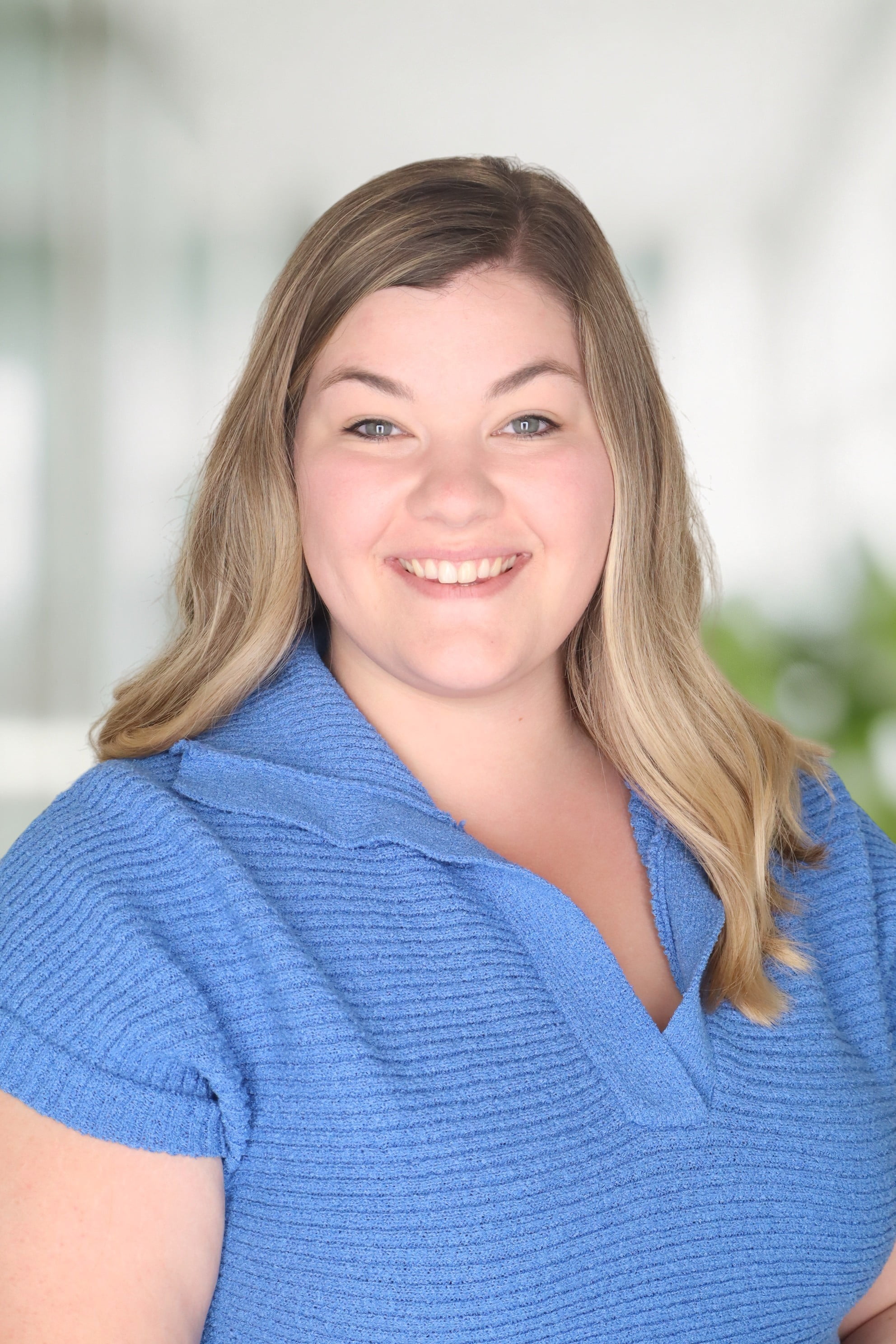 headshot of Mackenzie Smith smiling wearing blue shirt