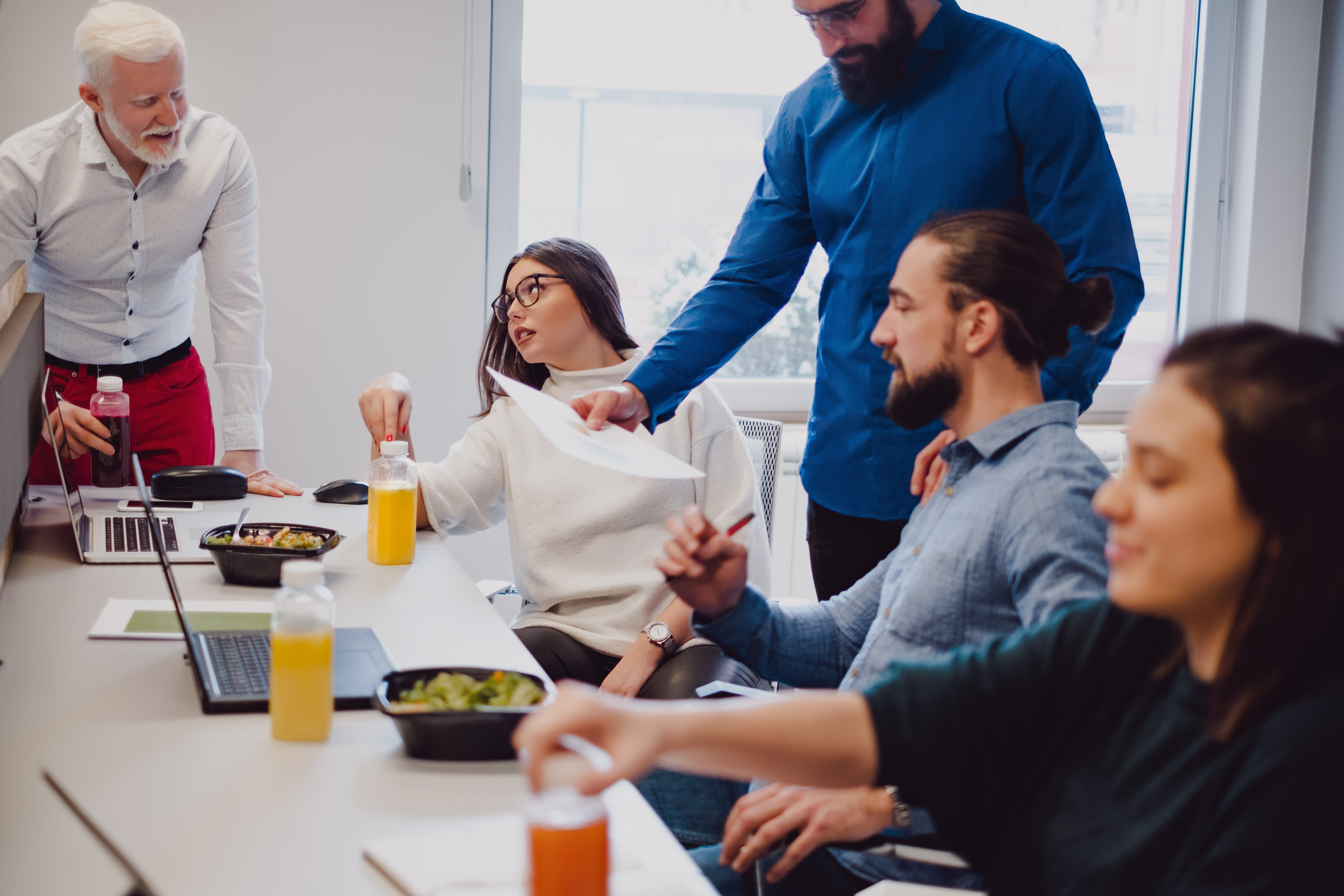 Group of people working and eating together