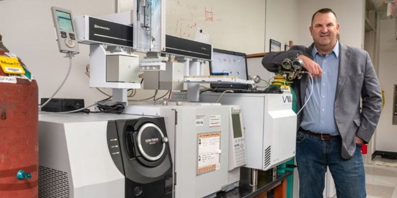 Kevin Schug, Professor and the Shimadzu Distinguished Professor of Analytical Chemistry, pictured next to lab equipment.