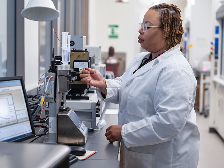 A graduate student works in a lab.