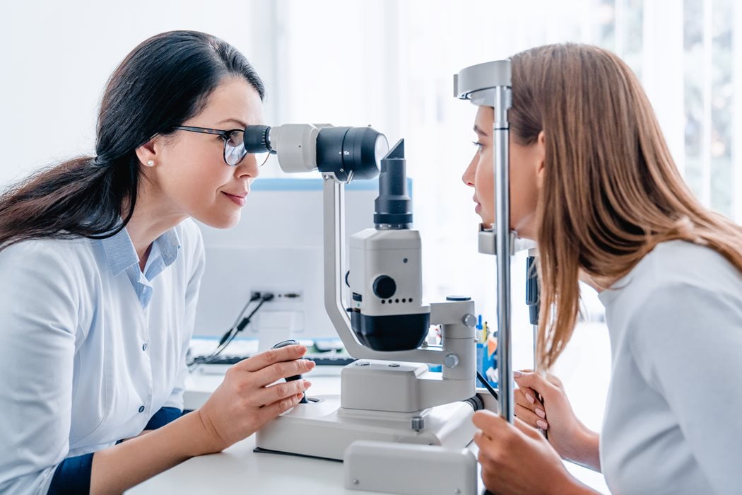 A doctor checking on a person using an optometry device
