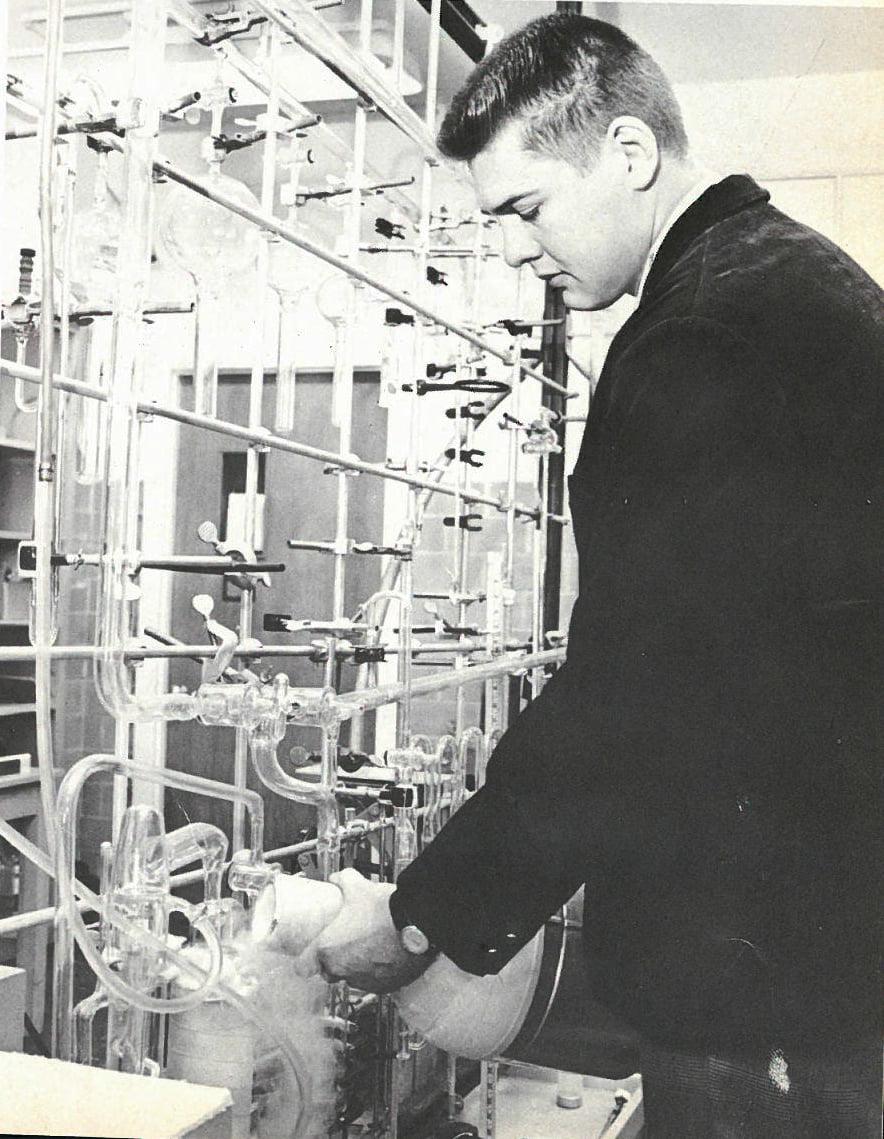 A student pours a solution in a chemistry lab in 1970.