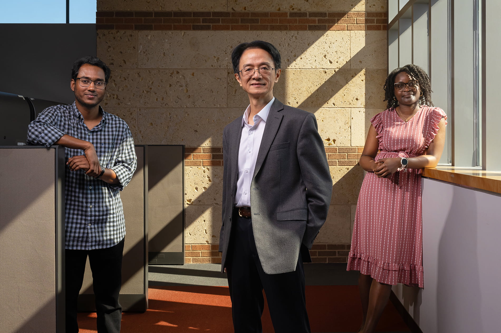 Mingwu Jin, UTA professor of physics, with graduate students Noor Rasel, left, and Darnisha Langlais, right.