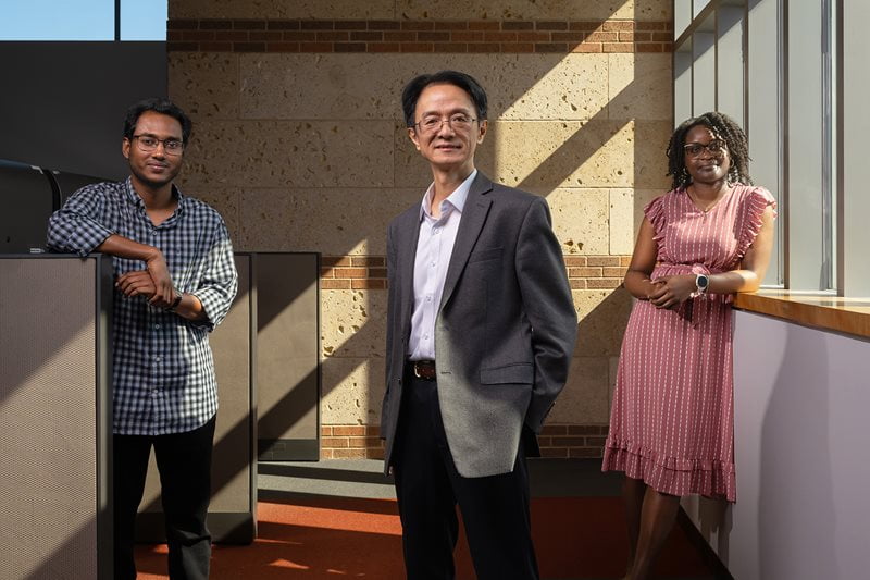 Mingwu Jin, UTA professor of physics, with graduate students Noor Rasel, left, and Darnisha Langlais, right.