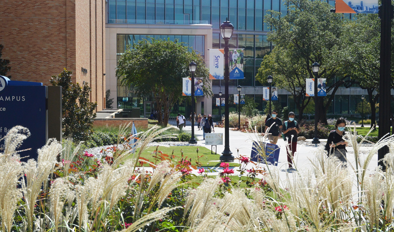 Students walking outside of the SEIR Building on a sunny day on campus.