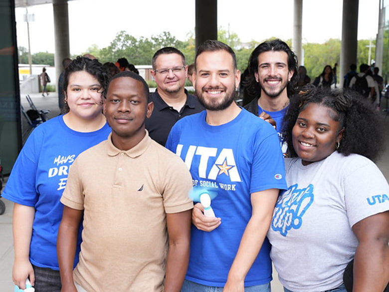 UTA student taking a group photo during School of Social Work Welcome Week.