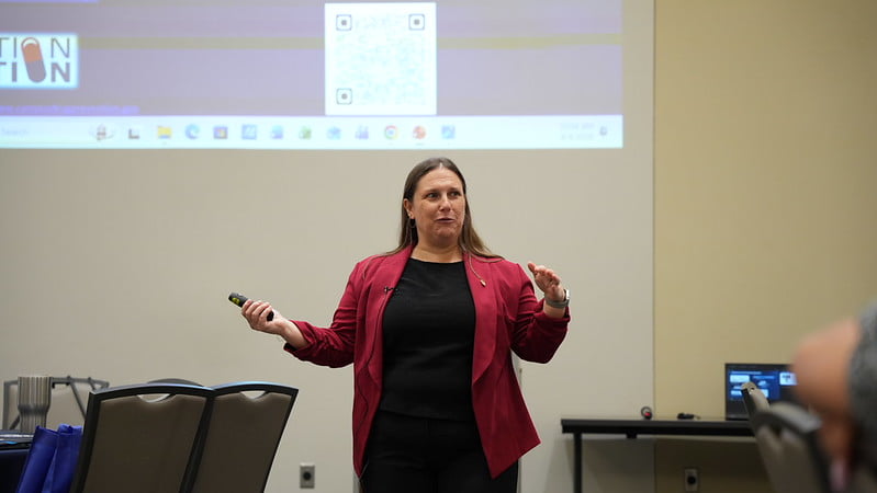 A person speaking to the audience during the Clouded Judgement event.