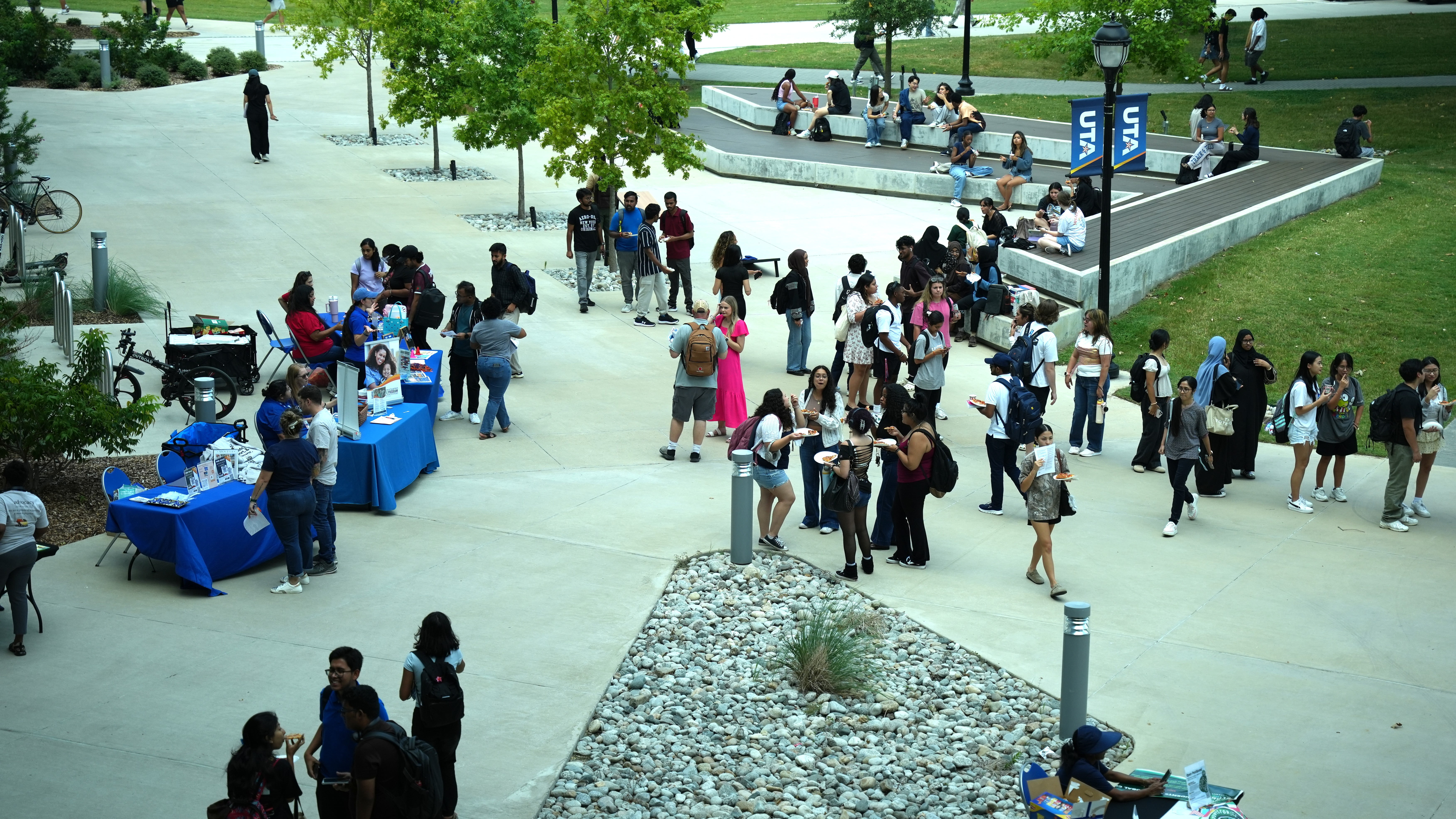 Student gathering in the courtyard during the Maverick Stampede - School of Social Work Welcome Back event.