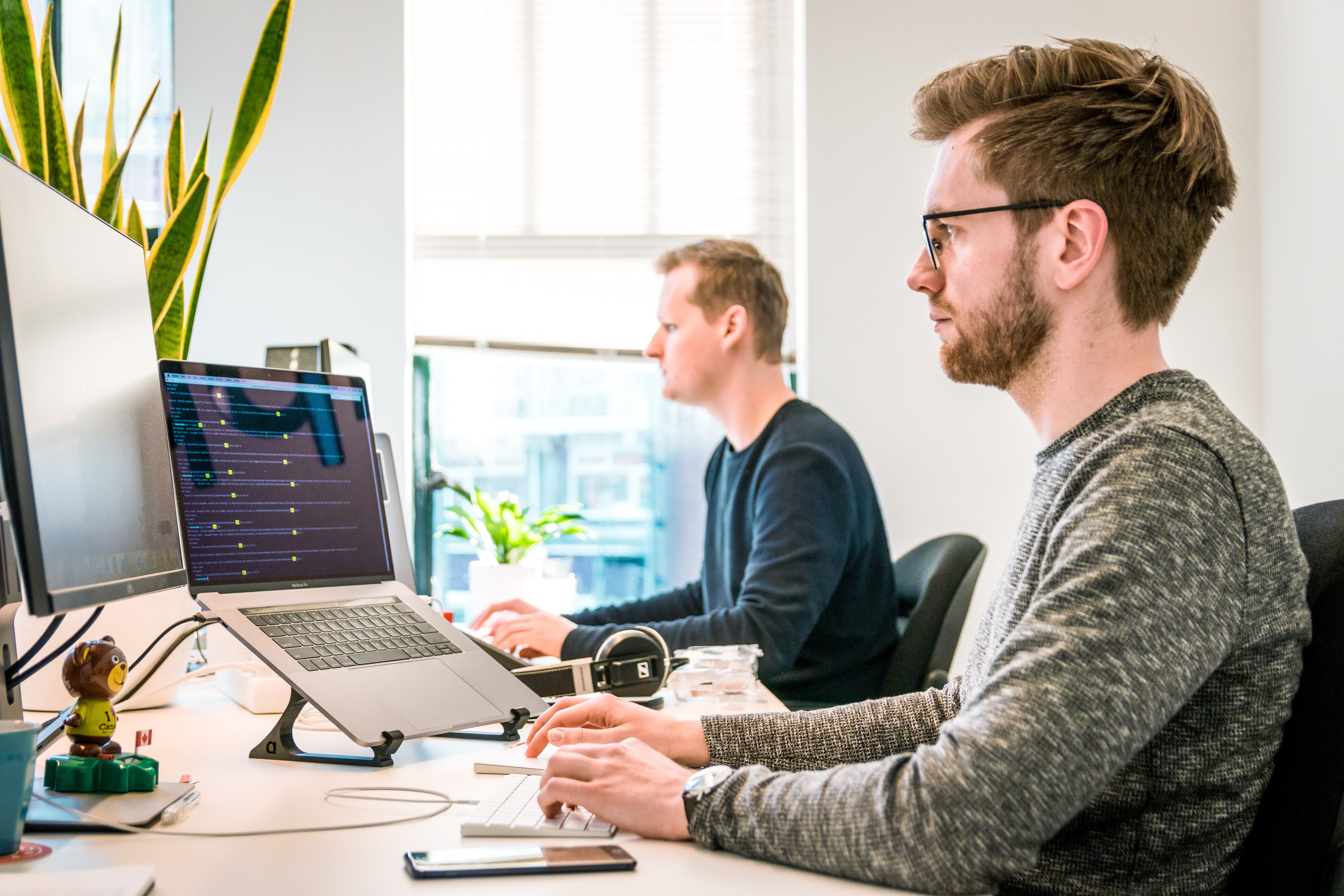 Men sitting at desk working on computer