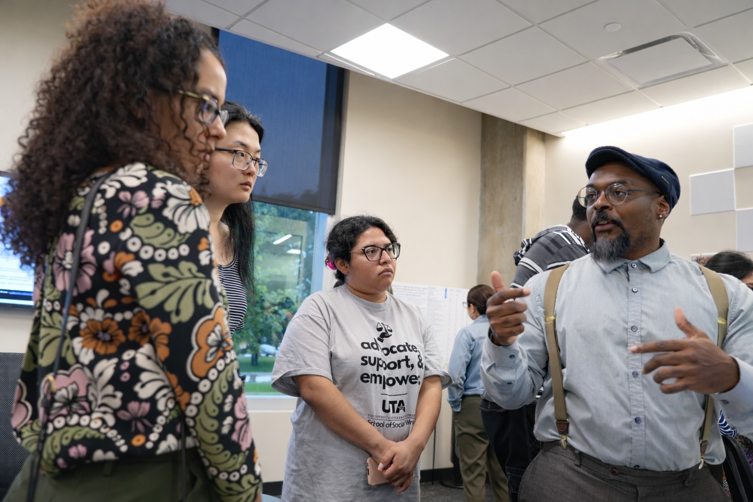 School of Social Work PhD students speaking with each other during a PhD event.