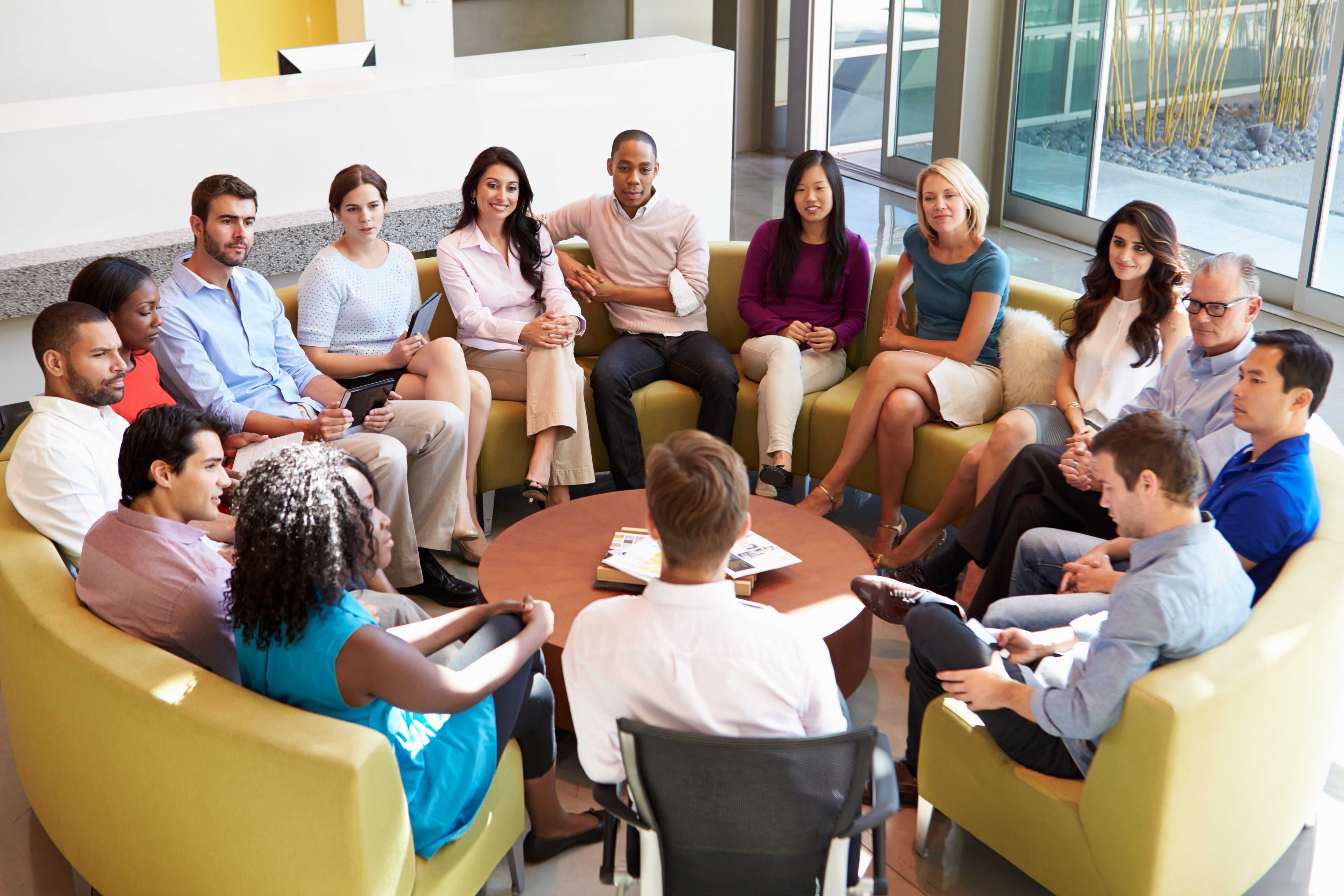 Multi-Cultural office staff sitting having a meeting