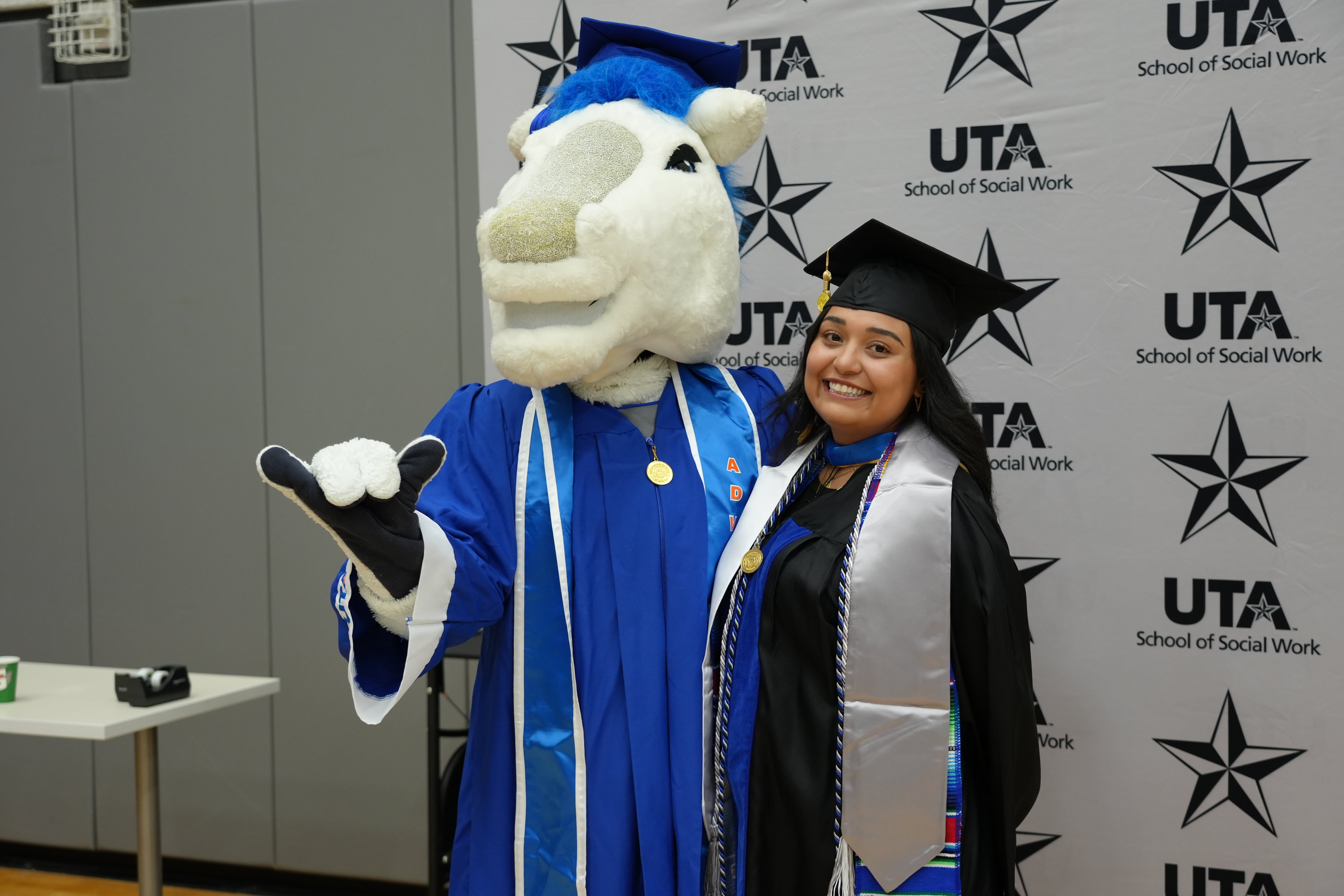 Summer 2025 Commencement photo of UTA mascot and a UTA School of Social Work student