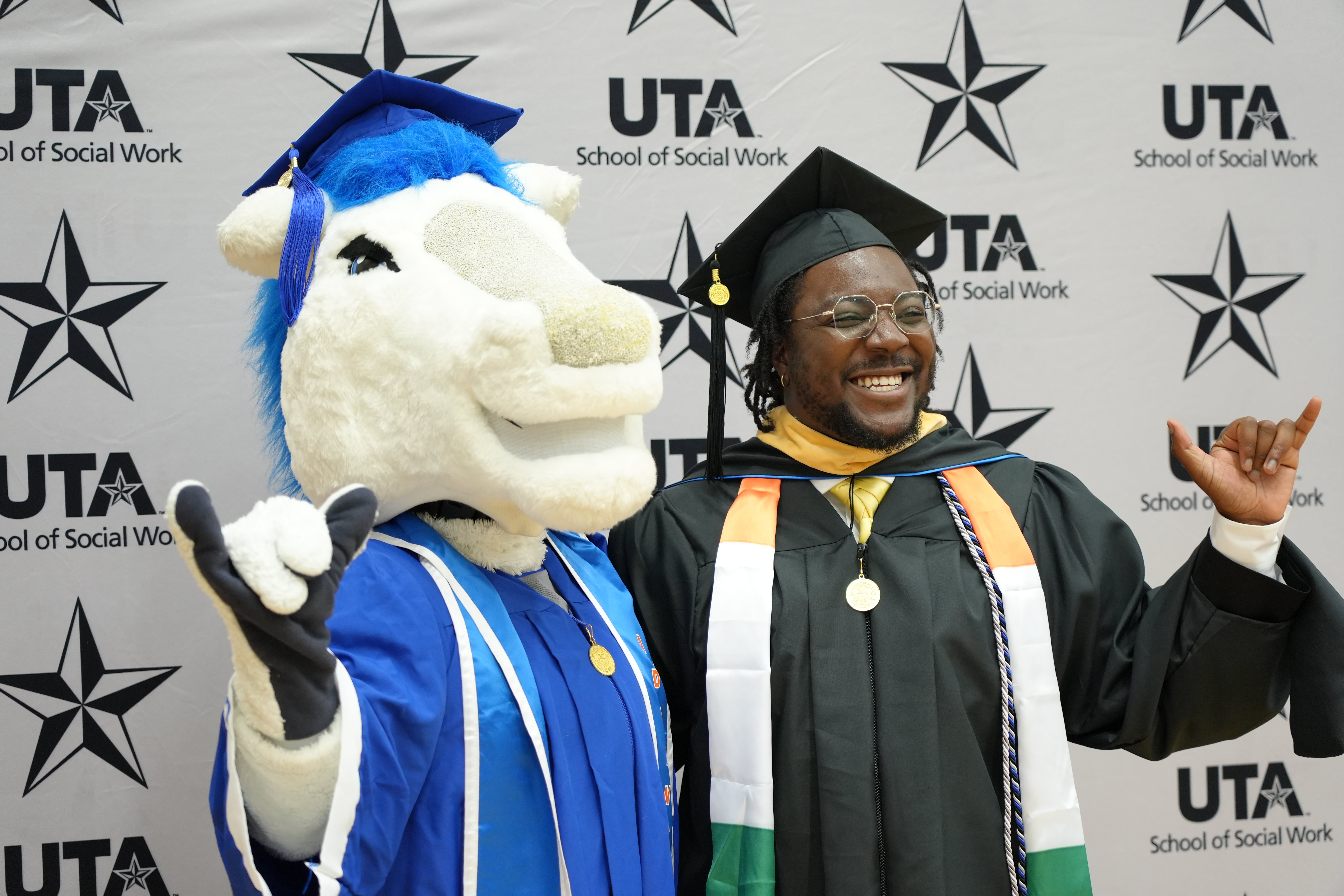 Summer 2025 Commencement photo of UTA mascot and a UTA School of Social Work student