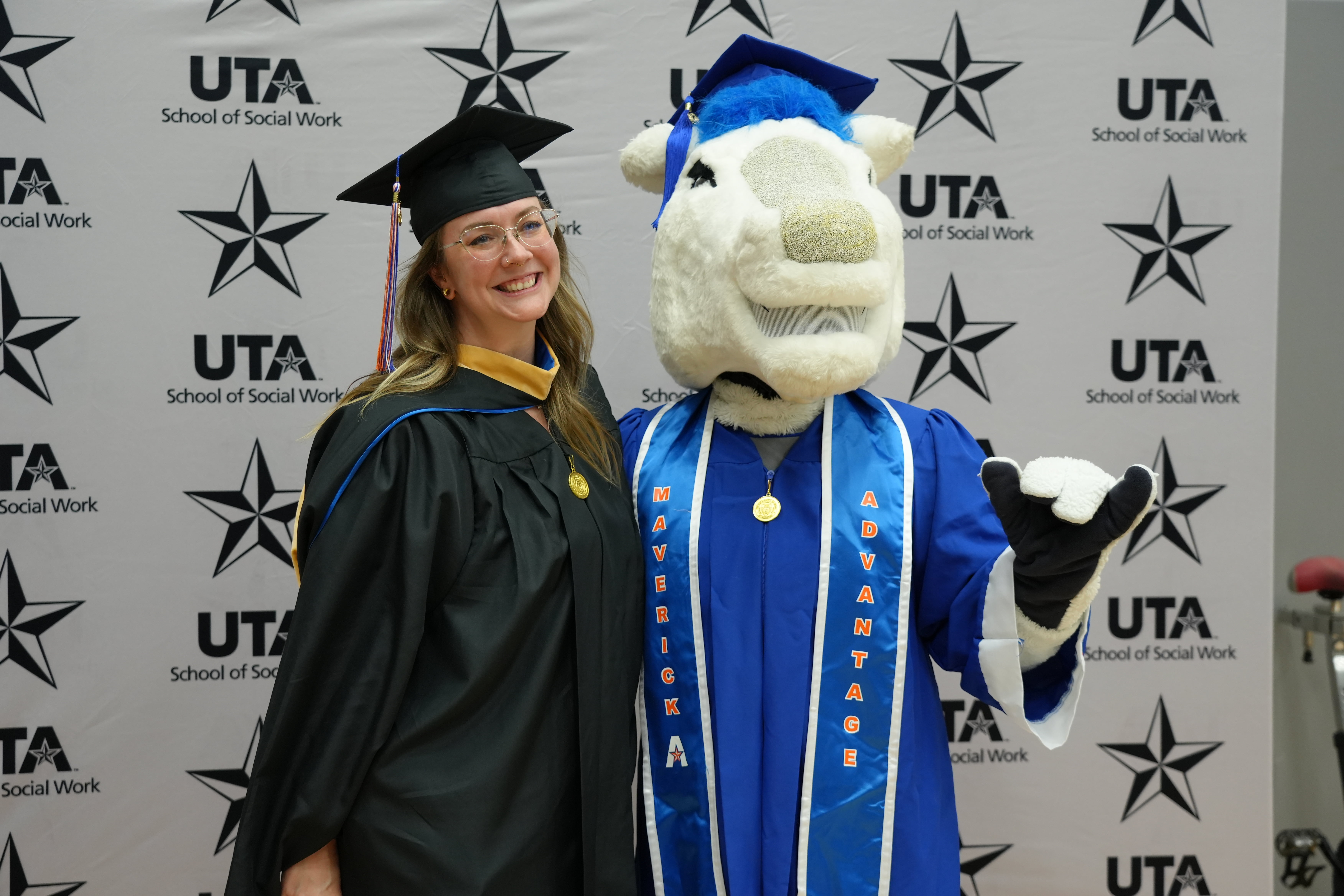 Summer 2025 Commencement photo of UTA mascot and a UTA School of Social Work student
