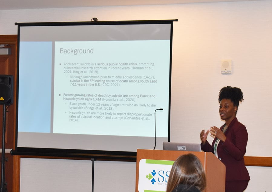 Dr. Danielle Harrell speaking during a conference