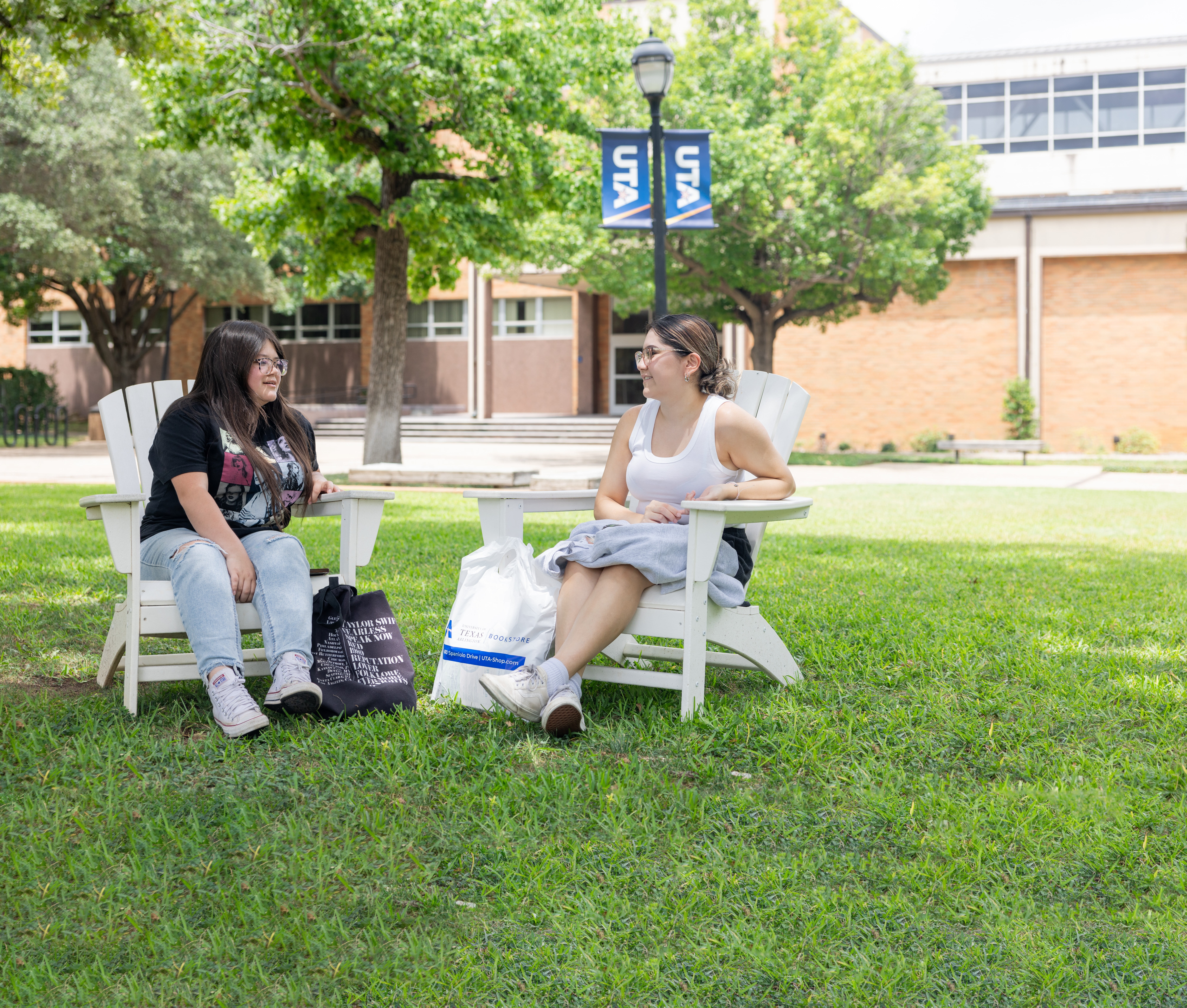 UTA students on campus sitting in courtyard