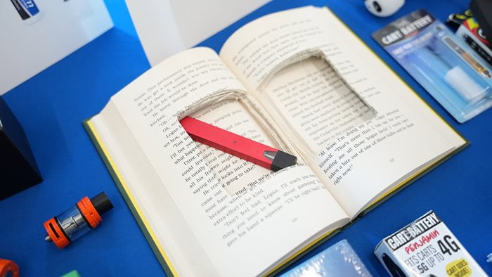 A vape sits inside of a book in a simulated display at the Clouded Judgement Symposium. (Photo by Doughlas Gutierrez)