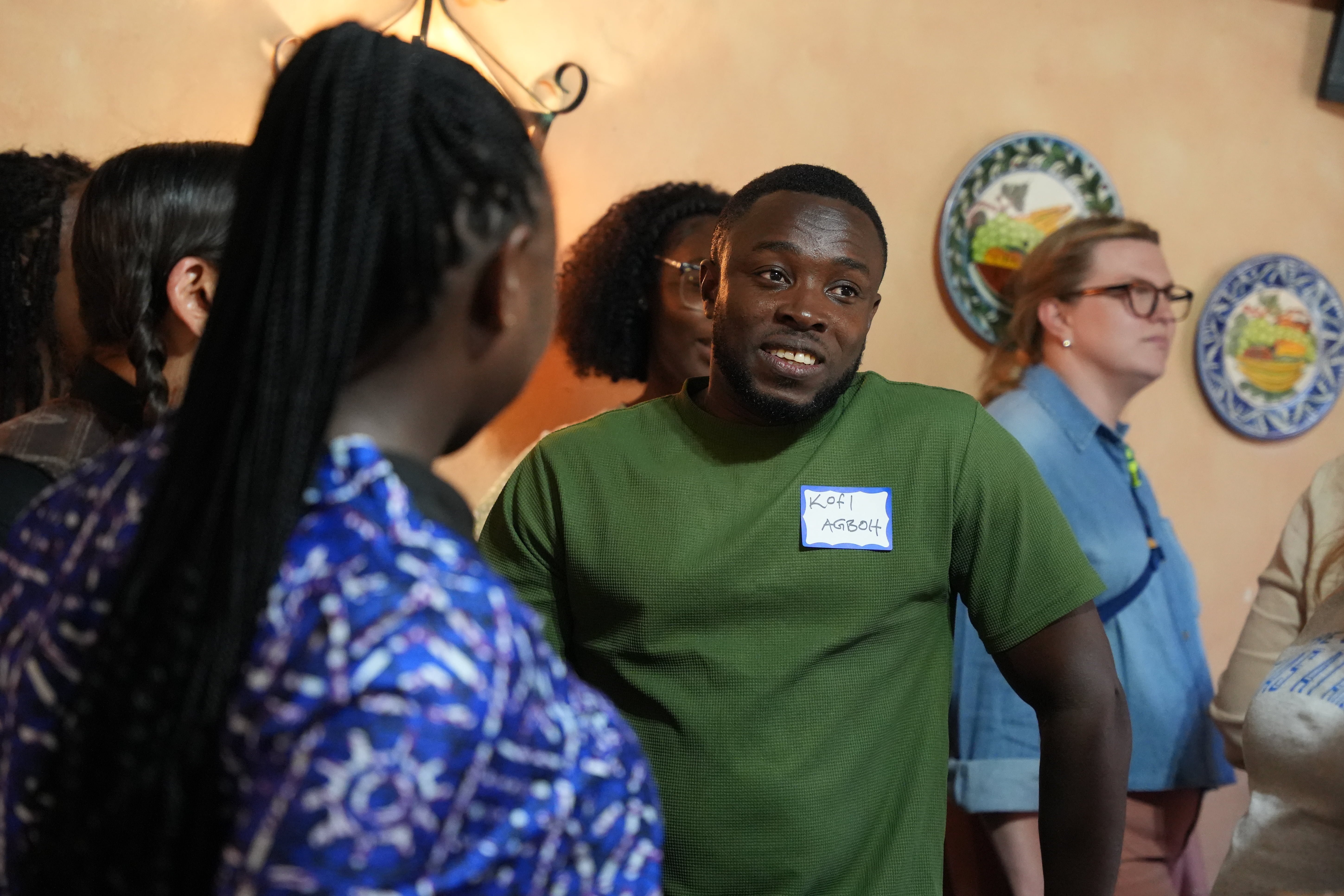 Kofi Agboh, a new PhD student at the University of Texas at Arlington School of Social Work, mingles with members of his cohort at the Faculty and PhD mixer event. 