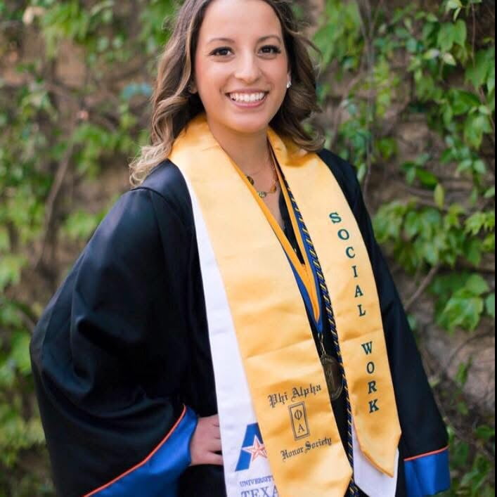 Lindsay Malhorta poses in her graduation gown.