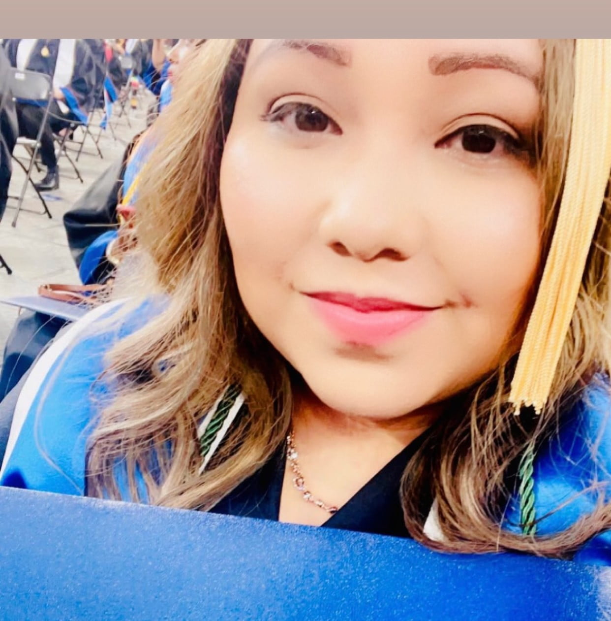 Maria Espiricueta Cruz poses with a diploma from the UTA School of Social Work.