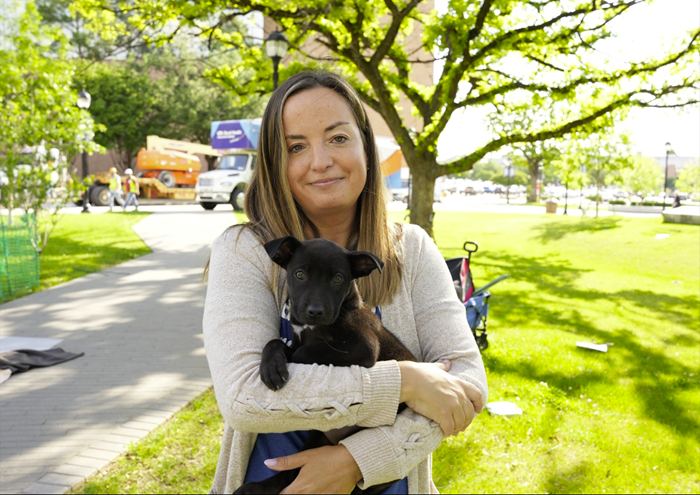 Dr. Dana Litt, vice president of Cowtown Friends of FWACC and professor in the School of Social Work, poses for a photo with a puppy during a Puppy Yoga Event in Spring 2025. (Photo by Doughlas Gutierrez)