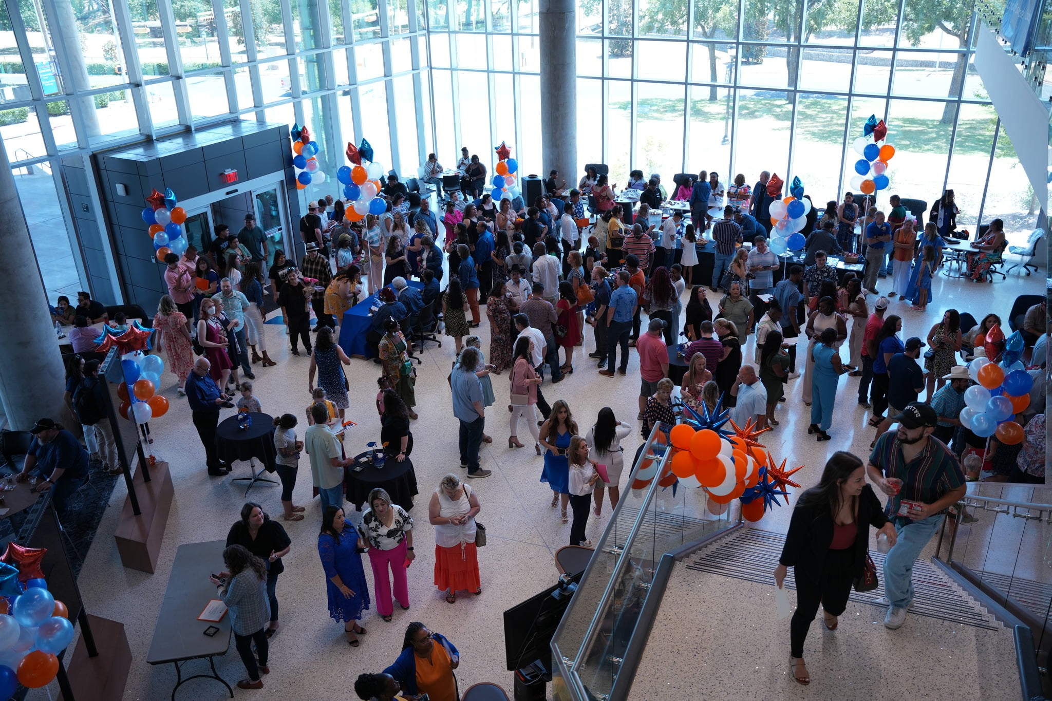 Students, faculty and staff in the lobby area of the School of Social Work and Smart Hospital building