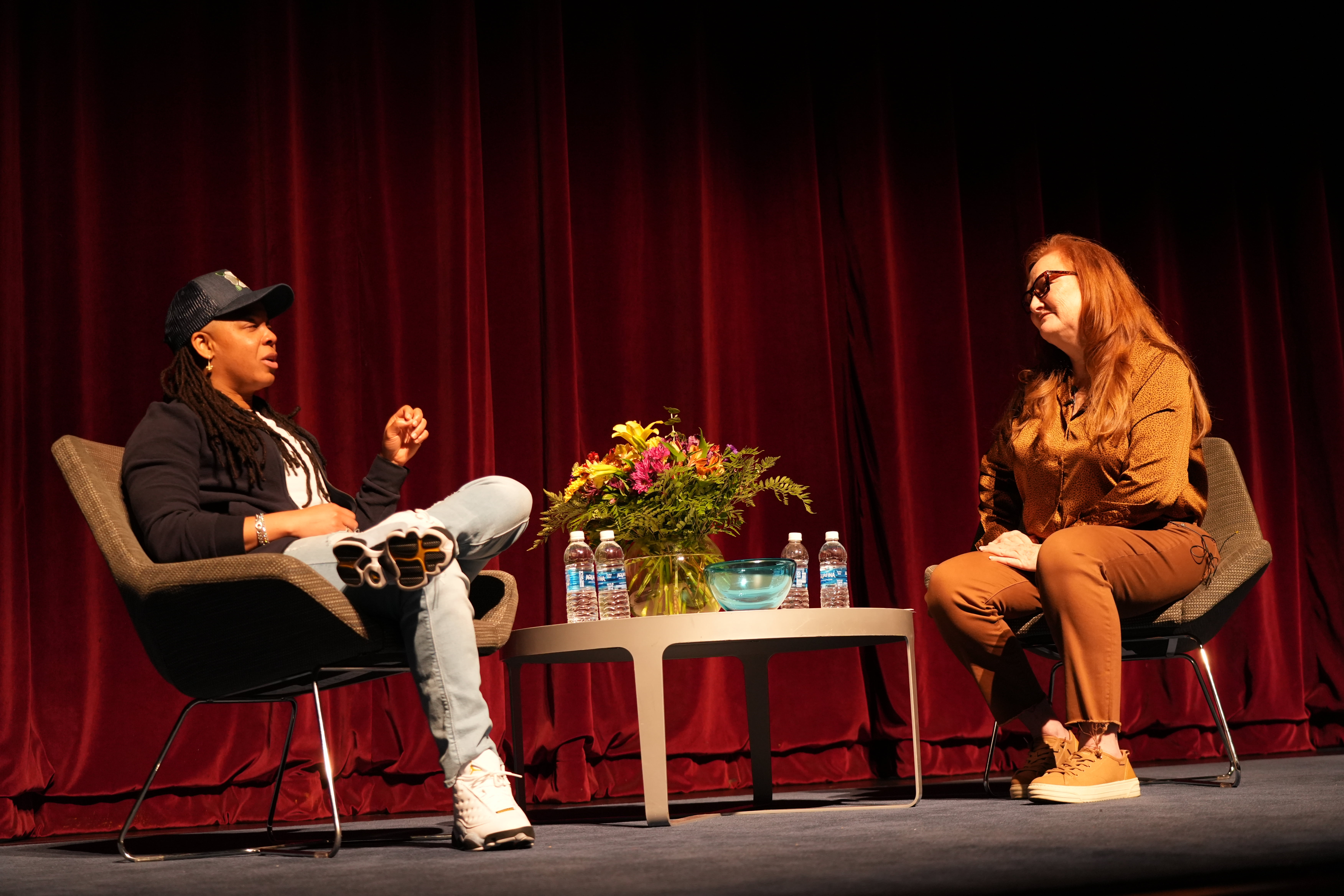 Punkie Johnson (left) and Dr. De'An Roper (right) speaking on stage at Texas Hall