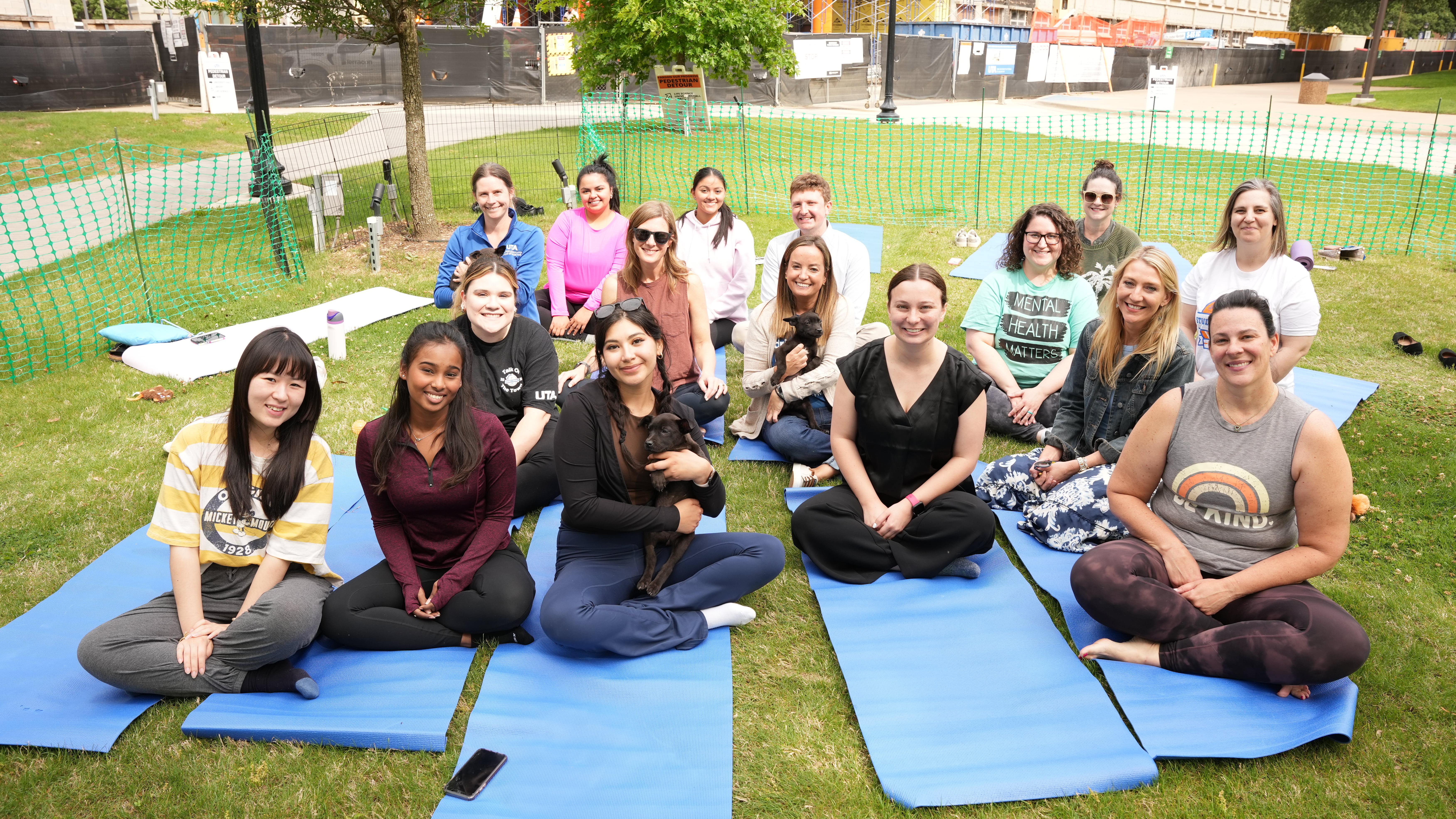 Social Work faculty and staff attend Puppy Yoga event.