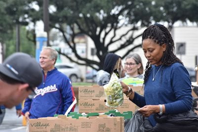 People giving away food during the 4th annual food giveaway and trunk or treat event