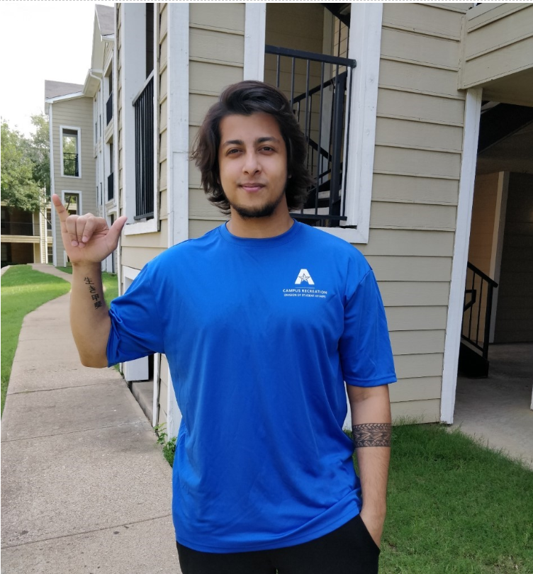 Abhishek in his campus rec shirt giving a mavs up hand sign