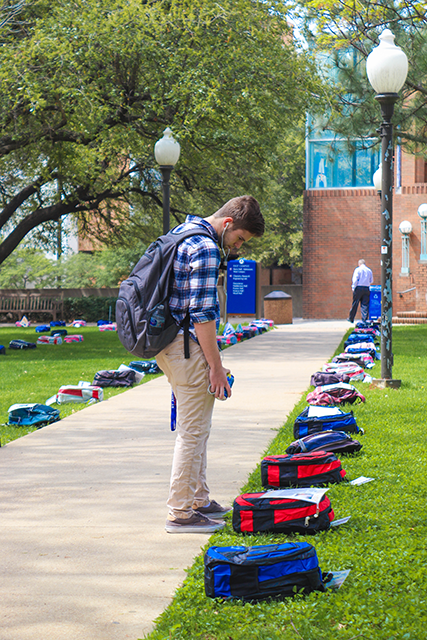 A student reading signs on a bag