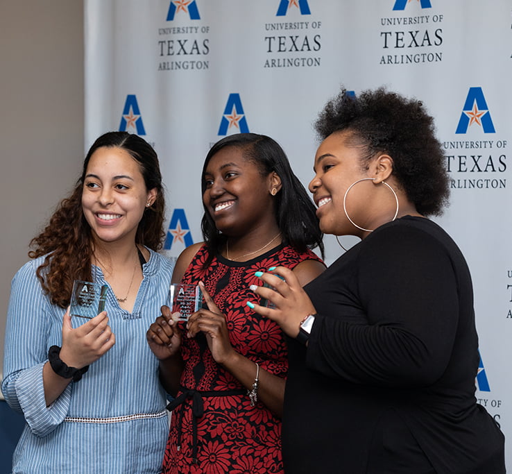 three girls with an award