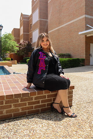 Karina Serrato sitting in a courtyard
