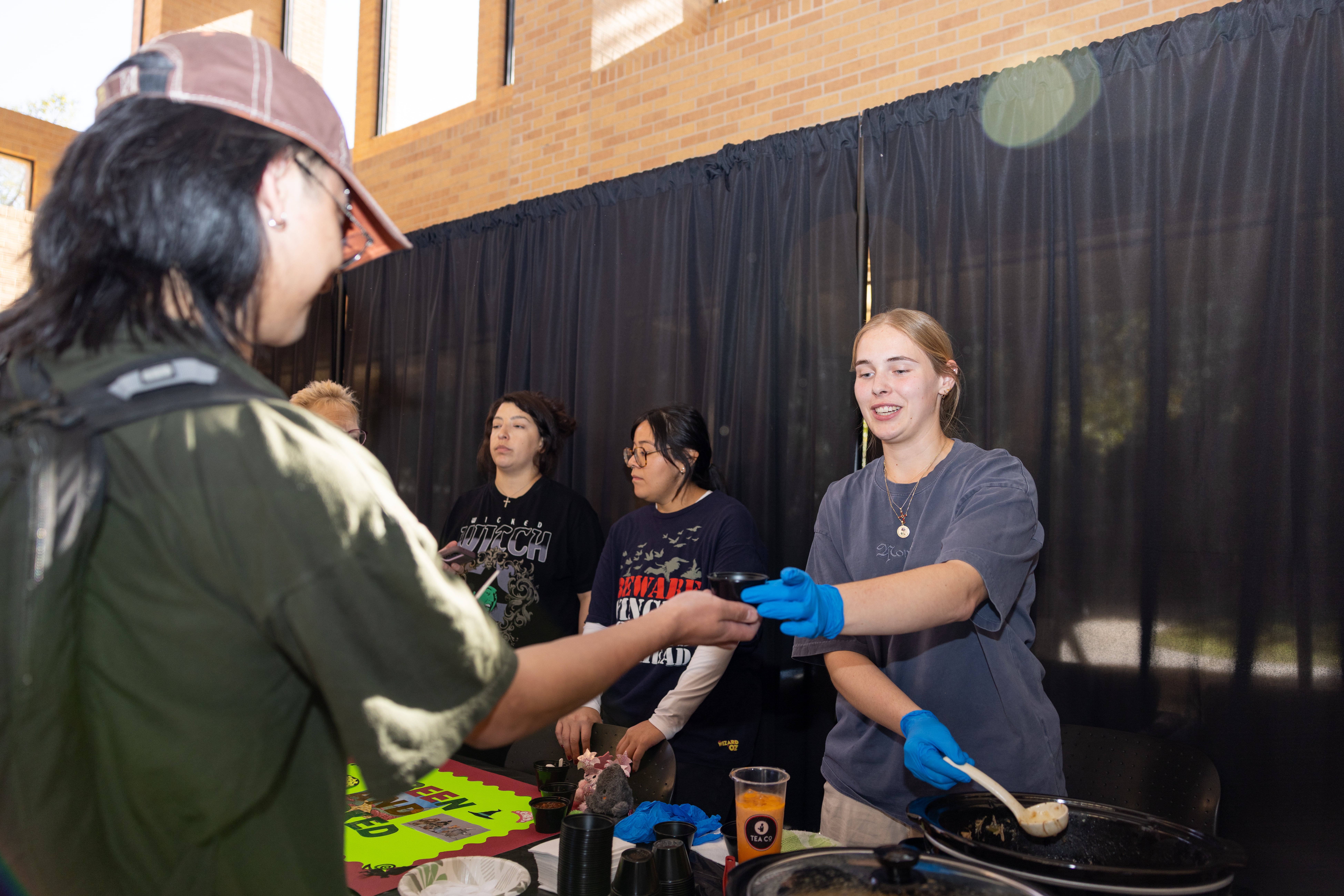 Student being served chili at the cook off event