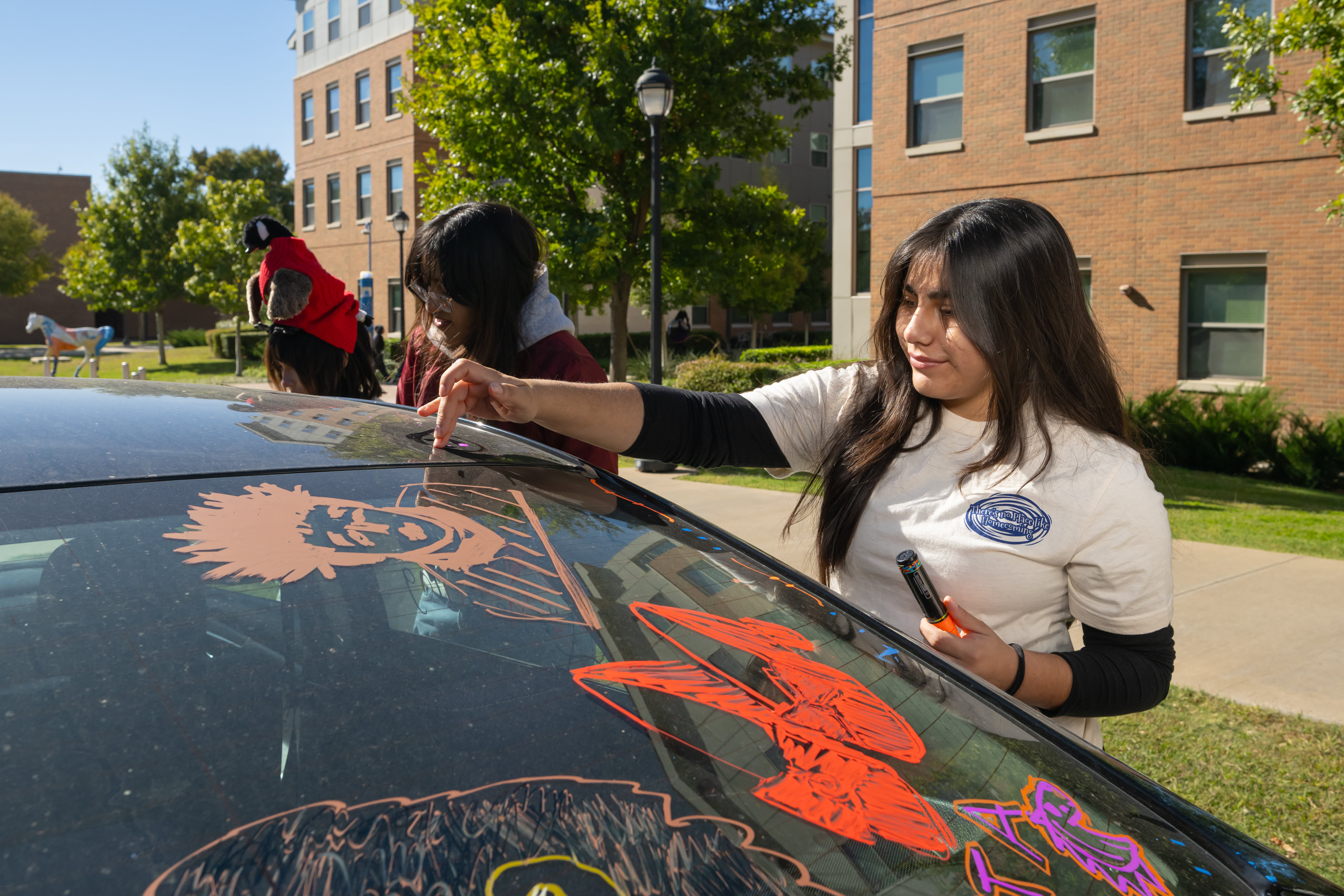 Students painting cars at the paint my ride event