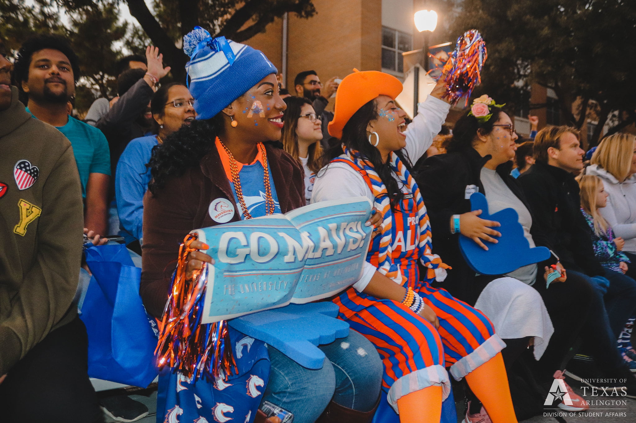 UTA students and a wrangler, a student spirit group, cheer while watching the UTA Homecoming Parade