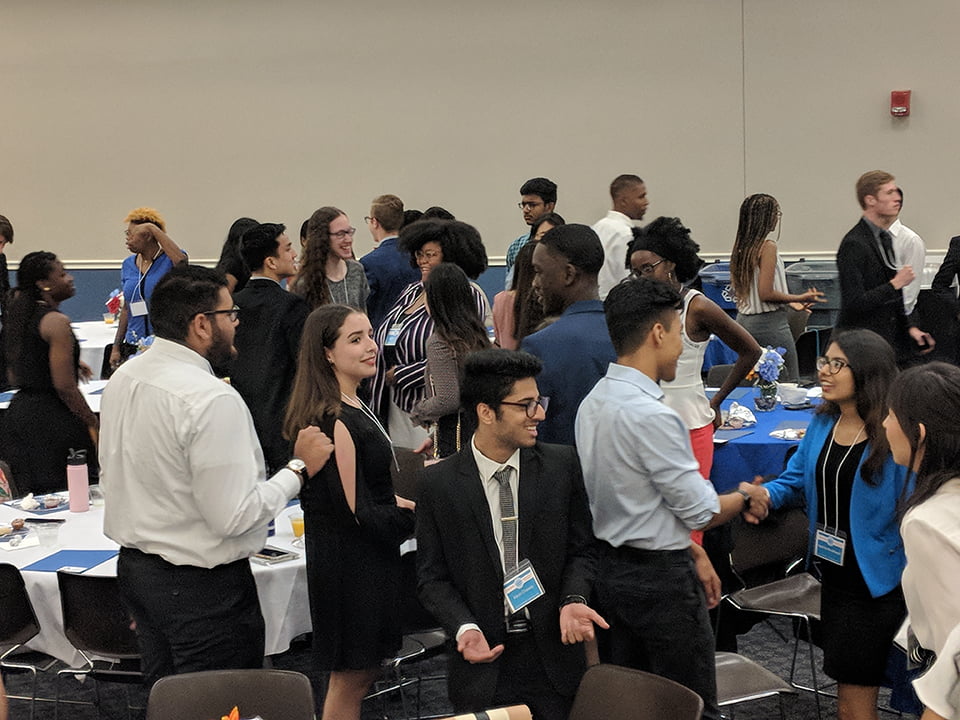 Group of students in formal wear doing an icebreaker activity
