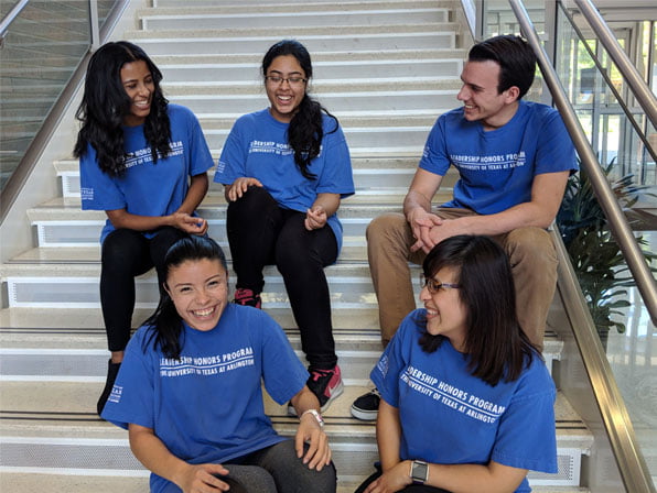 Leadership Honors Program students sitting on stairs and smiling