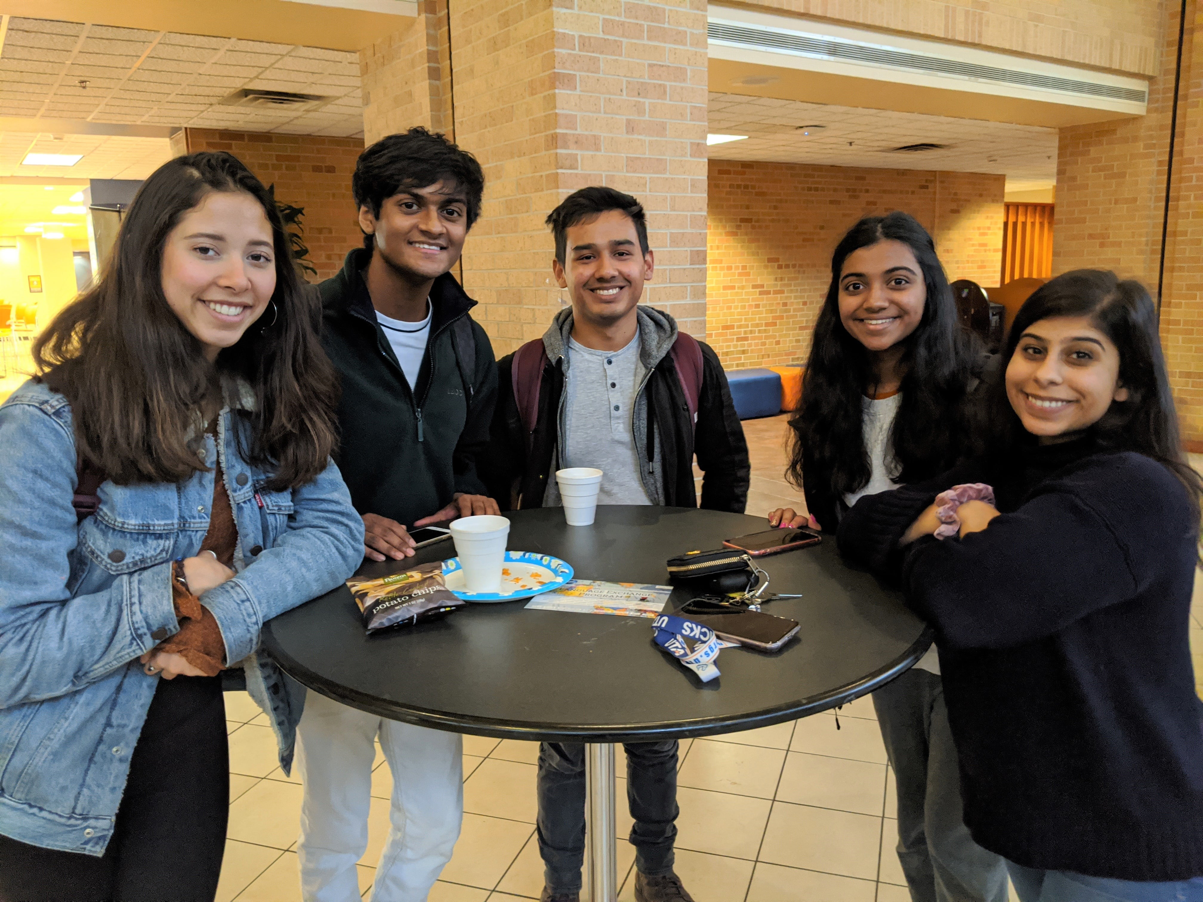 A group of students gathered around a table