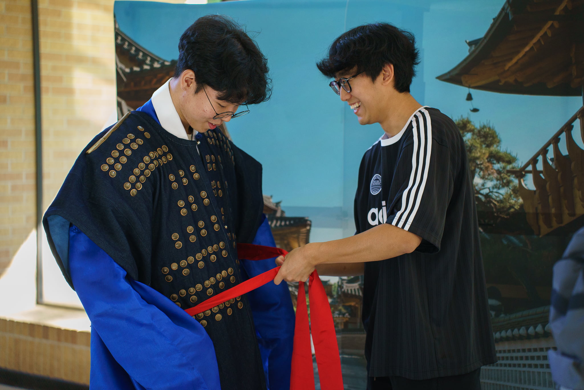 Student helping other student with his wardrobe 