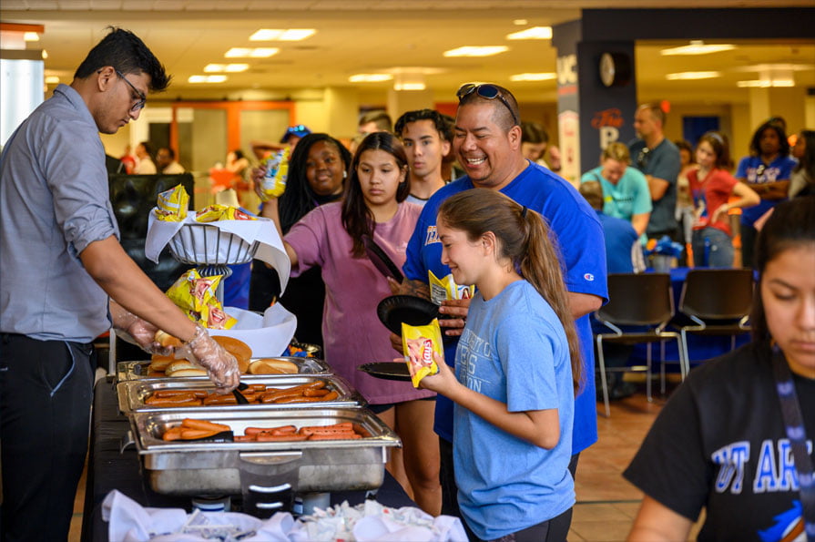 Families waiting in line for hot dogs
