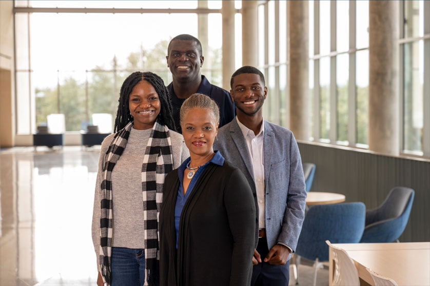 The Morralls with their son and daughter smiling in the SEIR Building