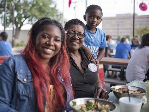 Happy family attending the Parent and Family Weekend dinner at Grease Monkey