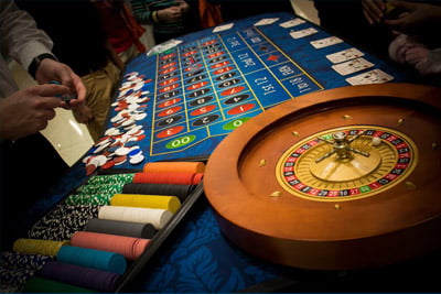 People around a poker table during Halloween Casino Night