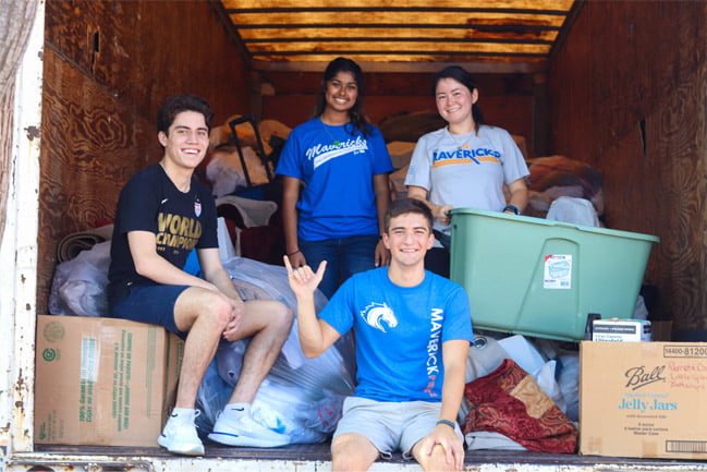 UTA students with cardboard boxes volunteering