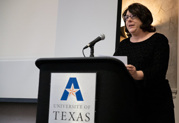 Laurie Fox speaking behind a UTA podium.