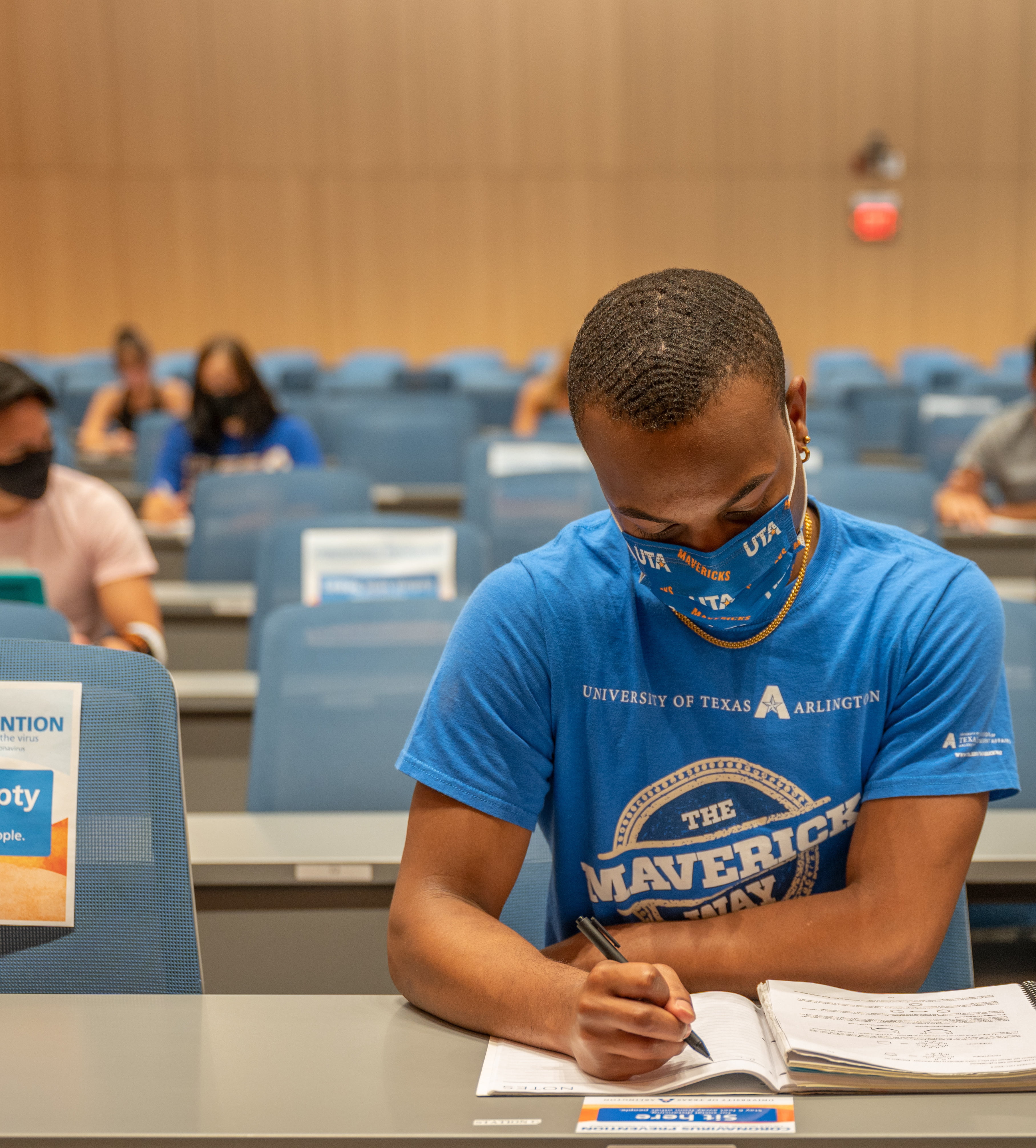 student in classroom wearing face-covering