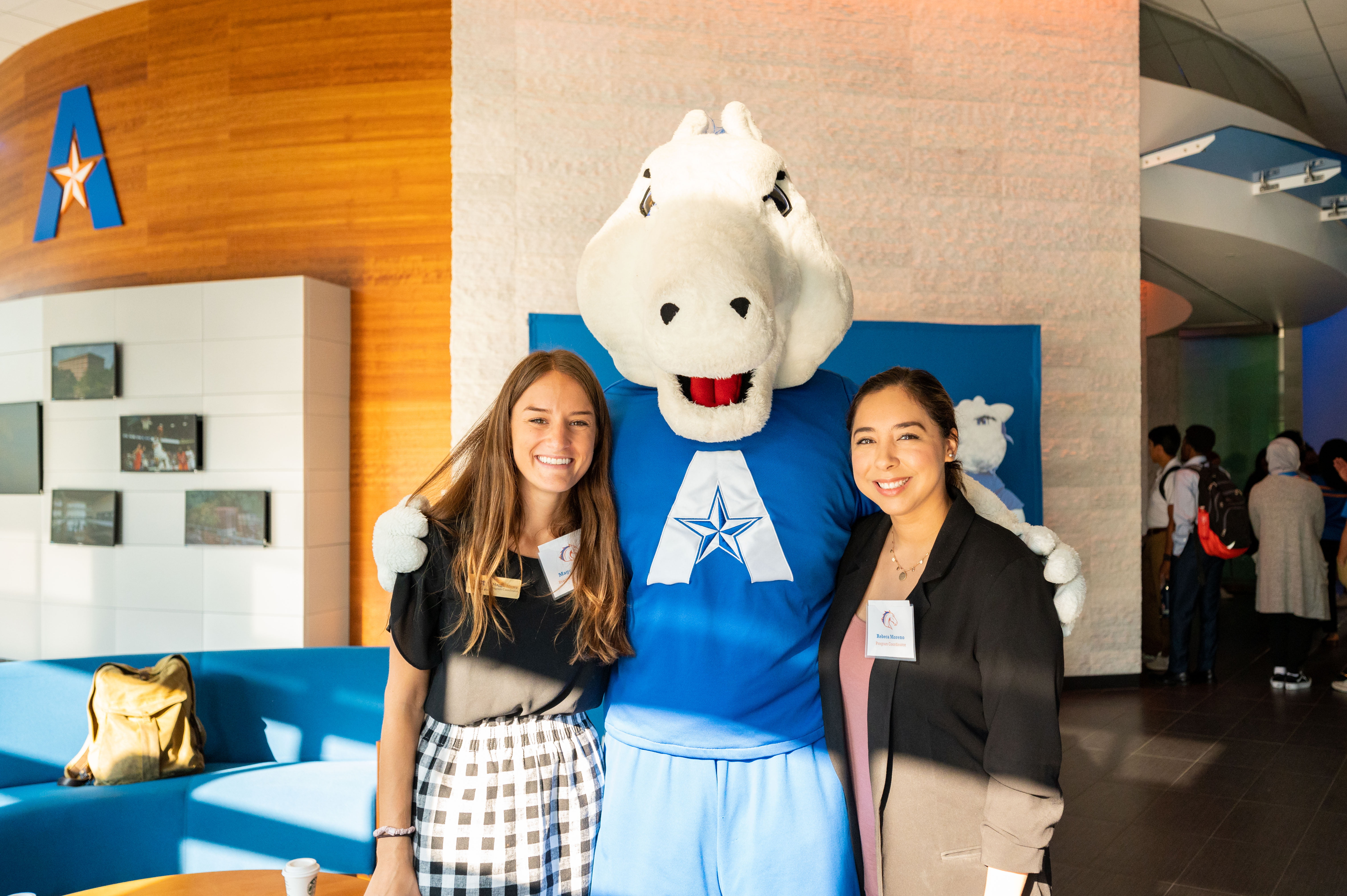 students standing with mascot